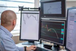 pexels-photo-5831264-5831264 Trader analyzing financial data on multiple monitors in an office setting.